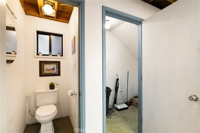 bathroom featuring toilet and vaulted ceiling