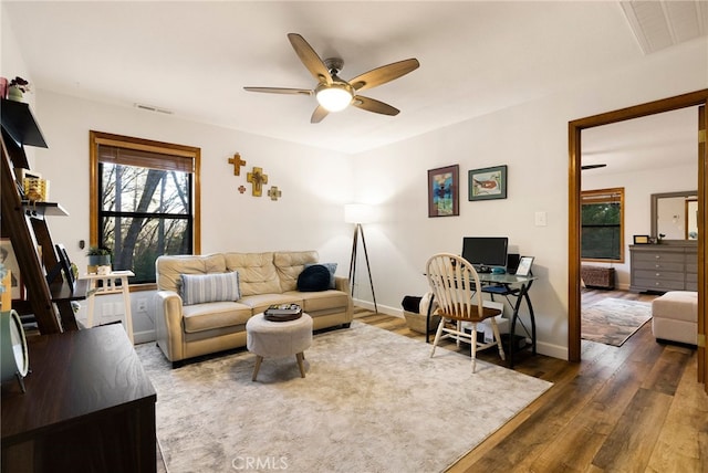 living room with ceiling fan and dark hardwood / wood-style floors