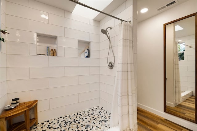 bathroom featuring walk in shower and hardwood / wood-style flooring