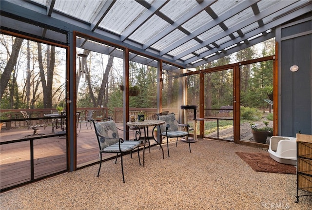 sunroom with a healthy amount of sunlight and vaulted ceiling