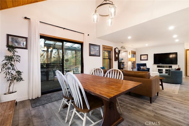 dining room with dark wood-type flooring and a chandelier