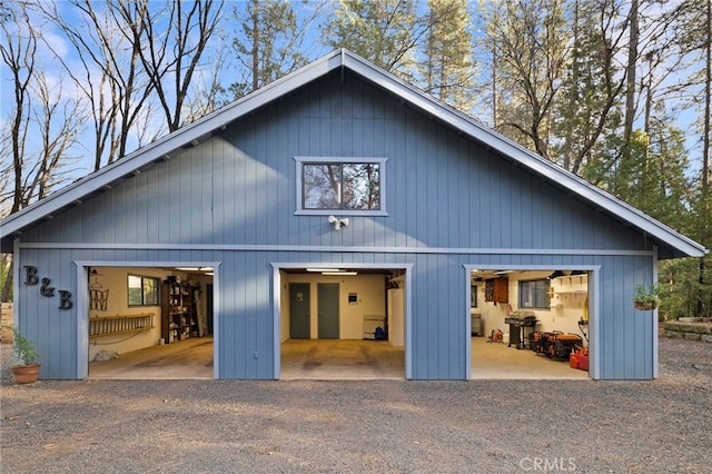 back of property with a garage and an outdoor structure