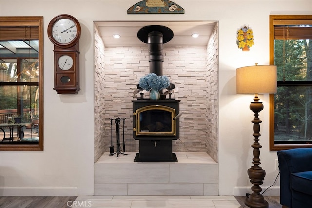 living room with a wood stove and hardwood / wood-style floors