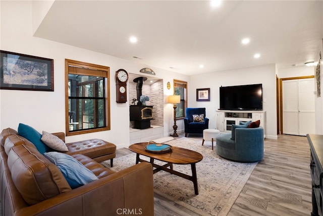 living room featuring hardwood / wood-style flooring and a wood stove