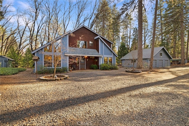 view of front of property featuring a garage and an outdoor structure