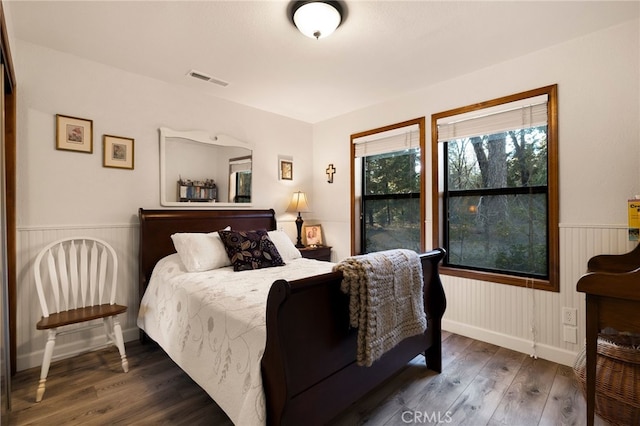 bedroom with dark wood-type flooring