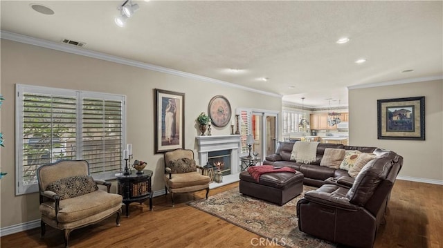 living room featuring crown molding and wood-type flooring