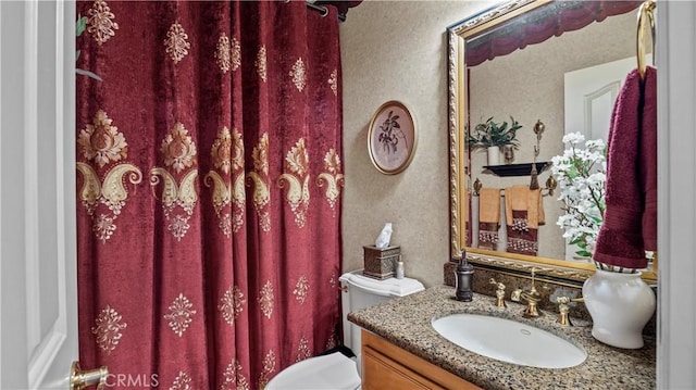 bathroom featuring toilet and vanity