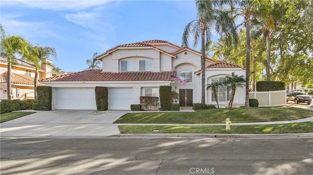 mediterranean / spanish-style house featuring a front yard and a garage