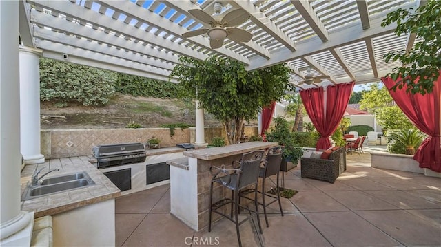 view of patio / terrace featuring grilling area, a pergola, ceiling fan, area for grilling, and a wet bar