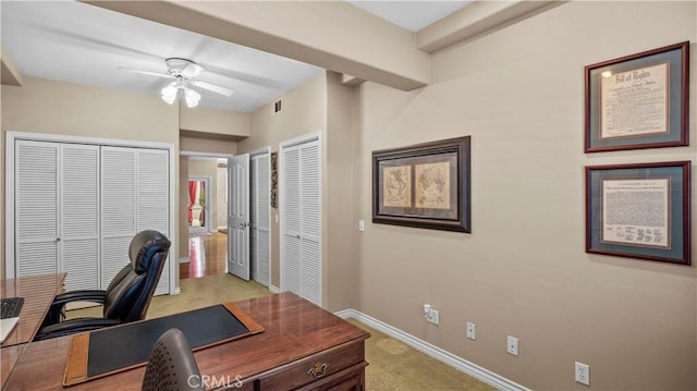 office space featuring ceiling fan and light carpet