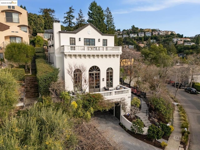 rear view of house with a carport and a balcony