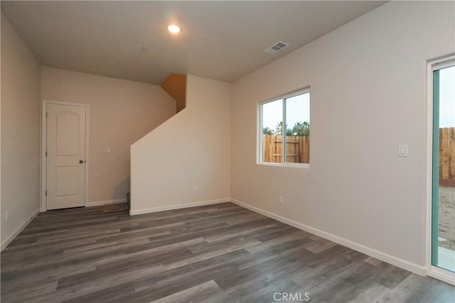 unfurnished room featuring dark hardwood / wood-style flooring