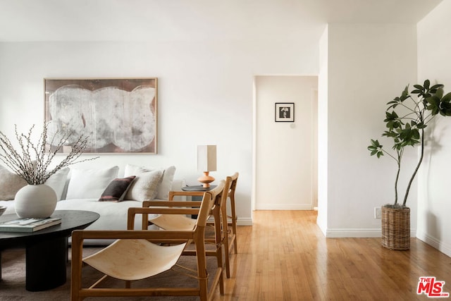 sitting room with hardwood / wood-style flooring