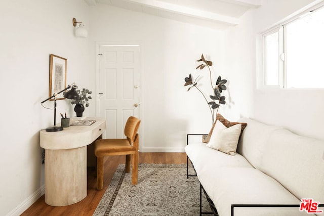 interior space featuring vaulted ceiling with beams and hardwood / wood-style flooring