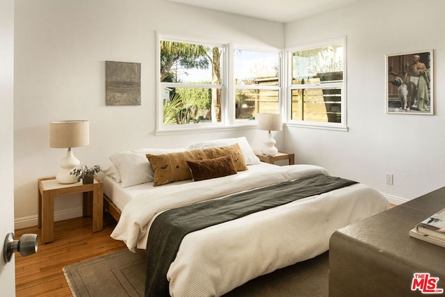 bedroom with hardwood / wood-style flooring