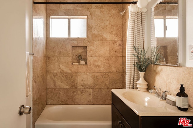 bathroom featuring vanity, a wealth of natural light, and shower / bath combo with shower curtain