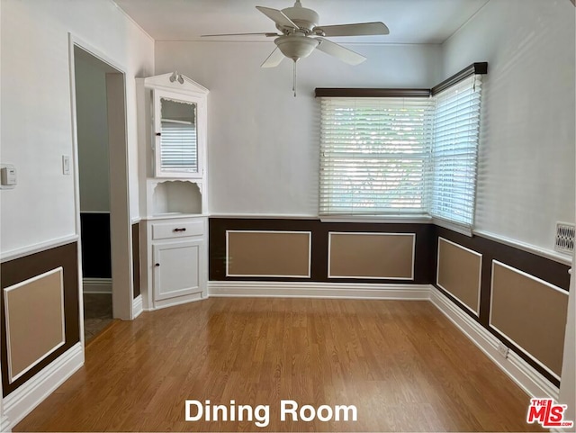 spare room with ceiling fan and light hardwood / wood-style flooring