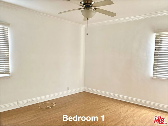 unfurnished room with ornamental molding, ceiling fan, and light wood-type flooring