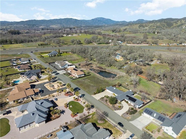 drone / aerial view featuring a residential view and a mountain view