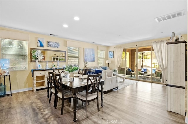 dining space with light wood-type flooring and plenty of natural light