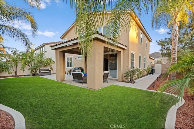 back of house with an outdoor living space, a patio, and a yard