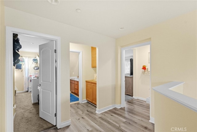 hallway with light hardwood / wood-style flooring