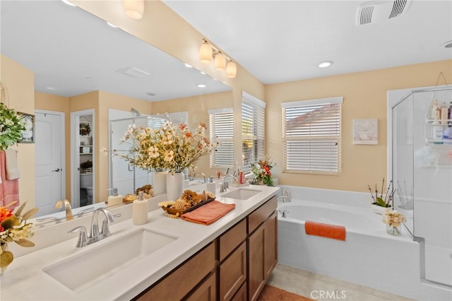 full bathroom with toilet, shower with separate bathtub, tile patterned floors, and vanity