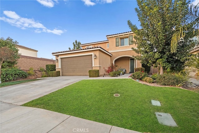 mediterranean / spanish home with a front lawn and a garage