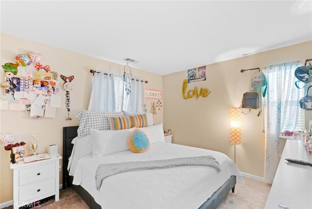 bedroom featuring light carpet