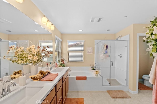 full bathroom featuring toilet, independent shower and bath, and vanity