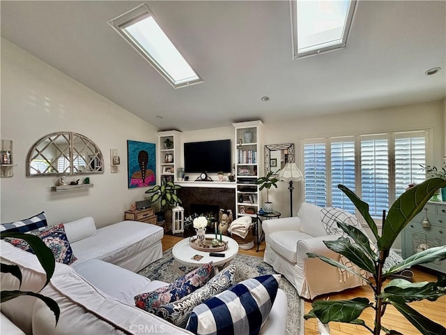 living room with lofted ceiling, a fireplace, and hardwood / wood-style flooring