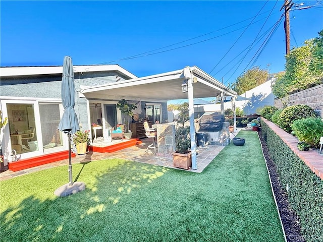 back of house featuring a patio and a lawn