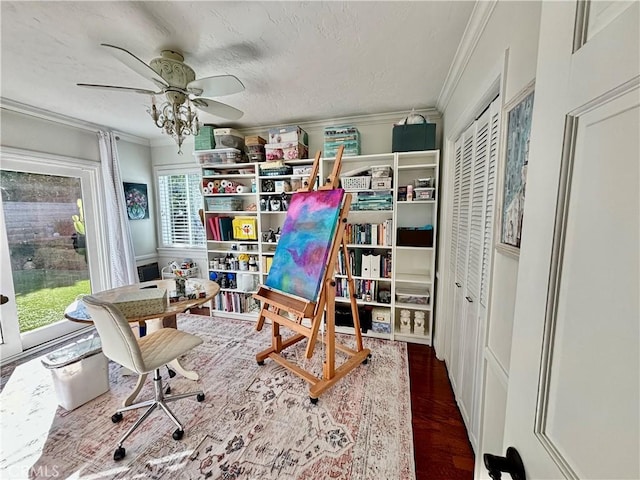 interior space featuring ceiling fan, ornamental molding, a textured ceiling, and hardwood / wood-style flooring