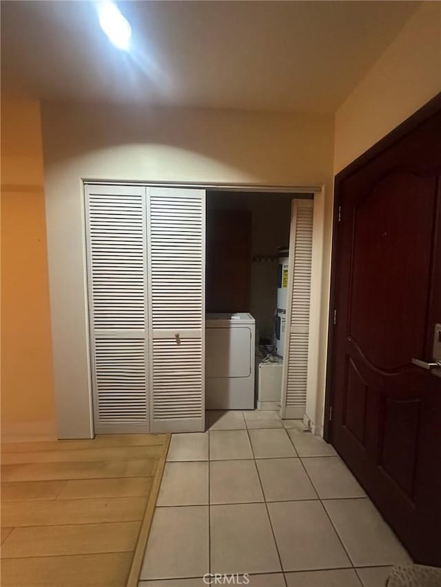 clothes washing area featuring washer / dryer and light tile patterned floors