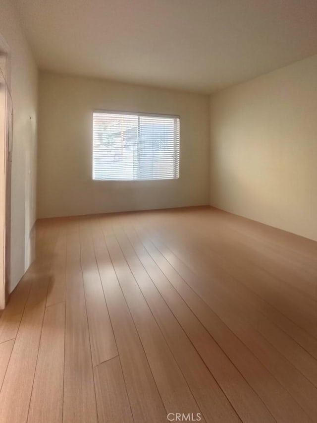 empty room with light hardwood / wood-style floors