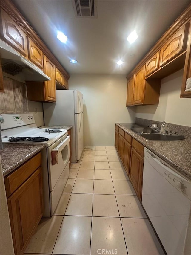 kitchen with sink, white appliances, and light tile patterned floors