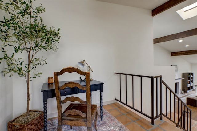 stairway with tile patterned floors and vaulted ceiling with skylight