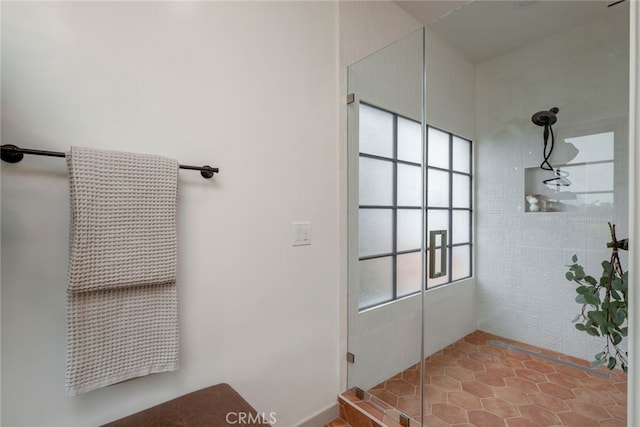 bathroom with a shower and a healthy amount of sunlight