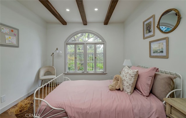 bedroom with beam ceiling