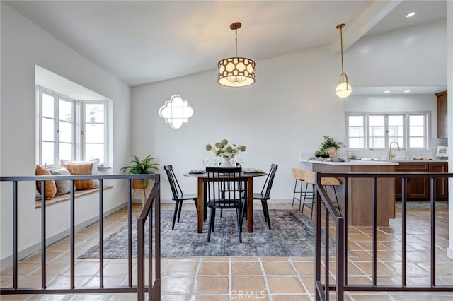 dining space with lofted ceiling and light tile patterned flooring