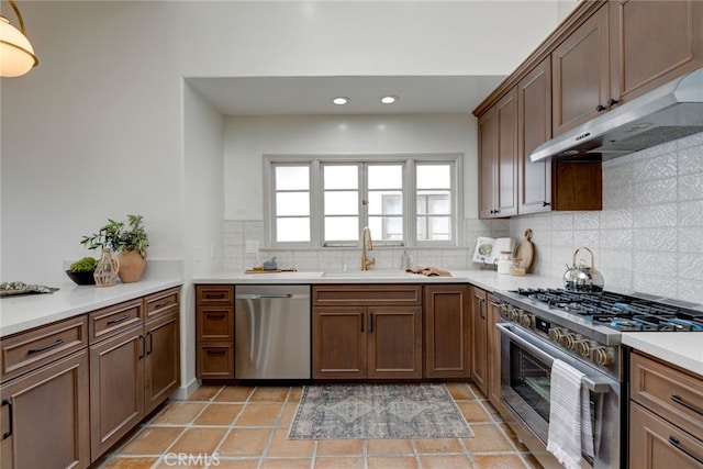 kitchen featuring sink, stainless steel appliances, light tile patterned flooring, and decorative backsplash