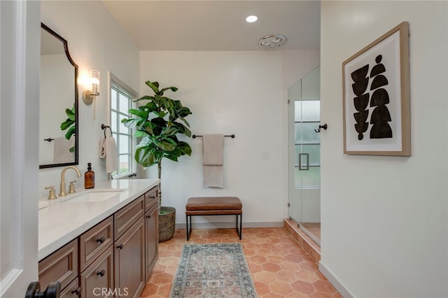 bathroom featuring vanity, tile patterned floors, and a shower with shower door