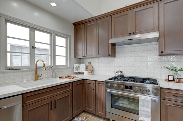 kitchen featuring sink, stainless steel appliances, backsplash, and light tile patterned floors