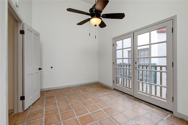 tiled spare room with ceiling fan