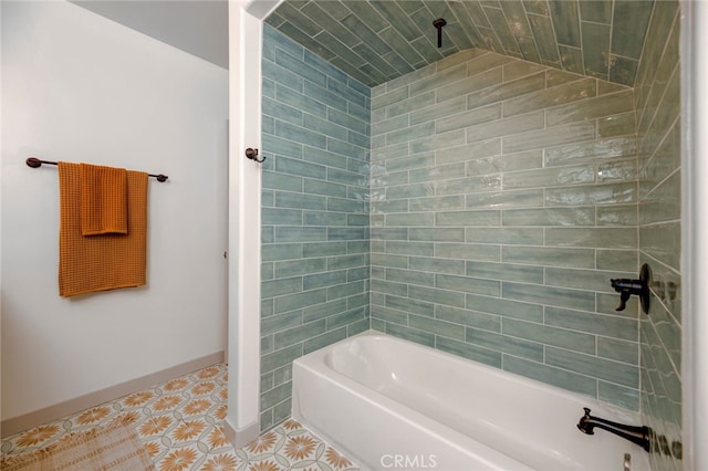 bathroom with vaulted ceiling, tile patterned floors, and tiled shower / bath