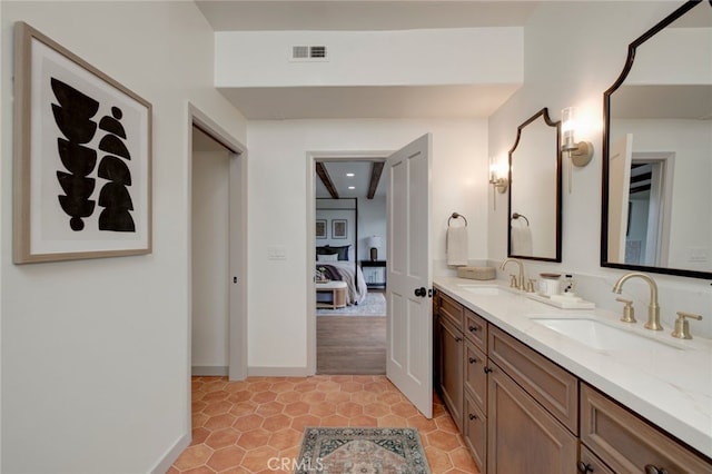 bathroom featuring tile patterned flooring and vanity