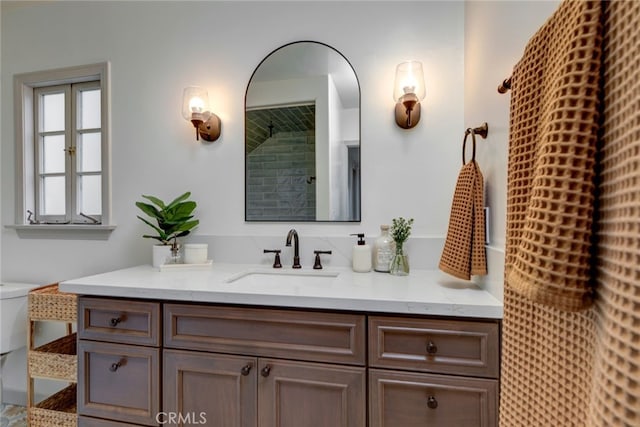 bathroom featuring toilet and vanity