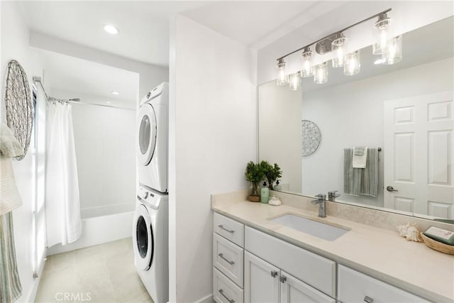 bathroom featuring vanity, shower / tub combo, and stacked washer / dryer