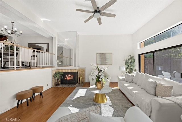 1824 S Marengo Ave Unit 27, Alhambra, CA 91803 - living room with wood finished floors, a ceiling fan, a chandelier, and a tiled fireplace